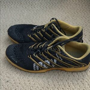 Inov-8 Black and Gold Athletic Shoes with Ventilated Design